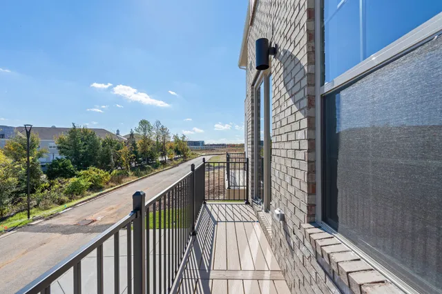 a balcony with view of balcony and wooden floor