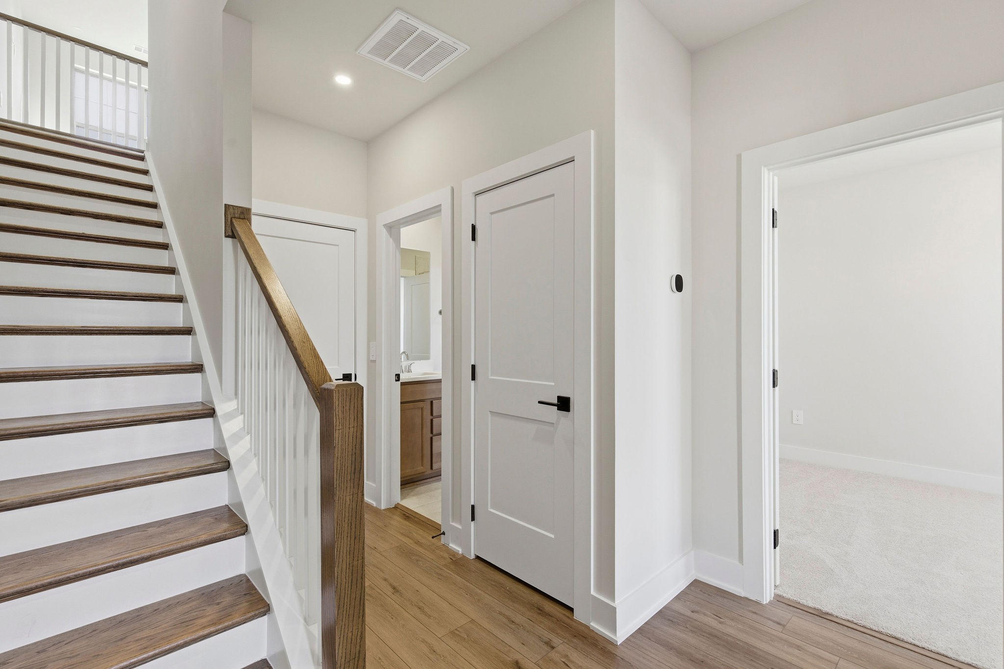 2615 Wilkinson Pike, Unit 1007 Murfreesboro, TN 37129 - Photo 2 of 43 a view of a hallway with wooden floor and staircase
