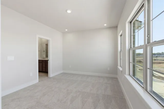 an empty room with windows and entrance