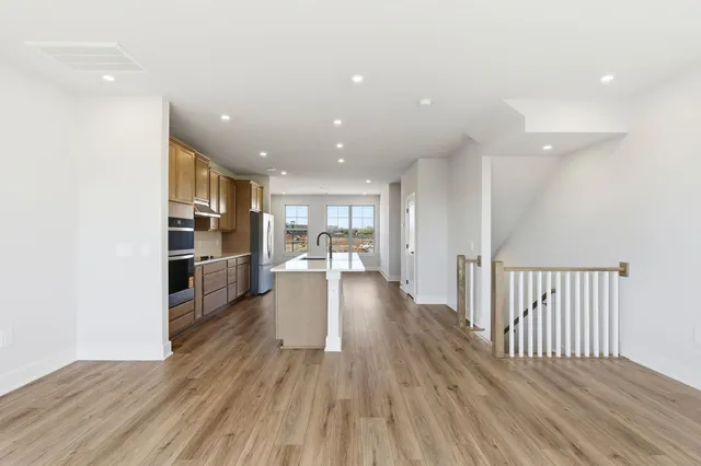 a view of a kitchen with wooden floor