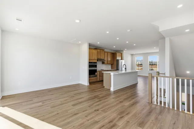 a view of kitchen with wooden floor and electronic appliances