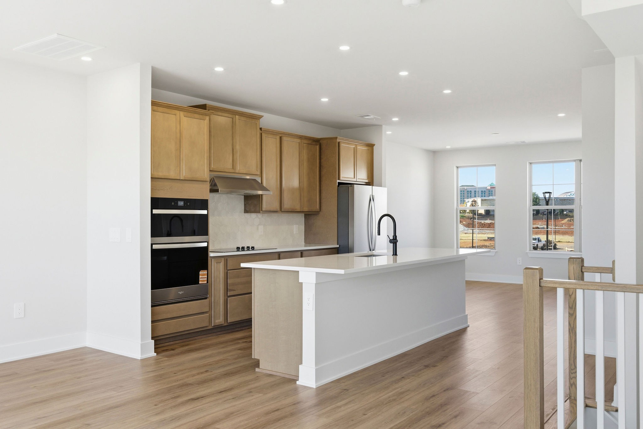 2615 Wilkinson Pike, Unit 1007 Murfreesboro, TN 37129 - Photo 8 of 43 a large kitchen with stainless steel appliances granite countertop a stove a sink a refrigerator and white cabinets with wooden floor