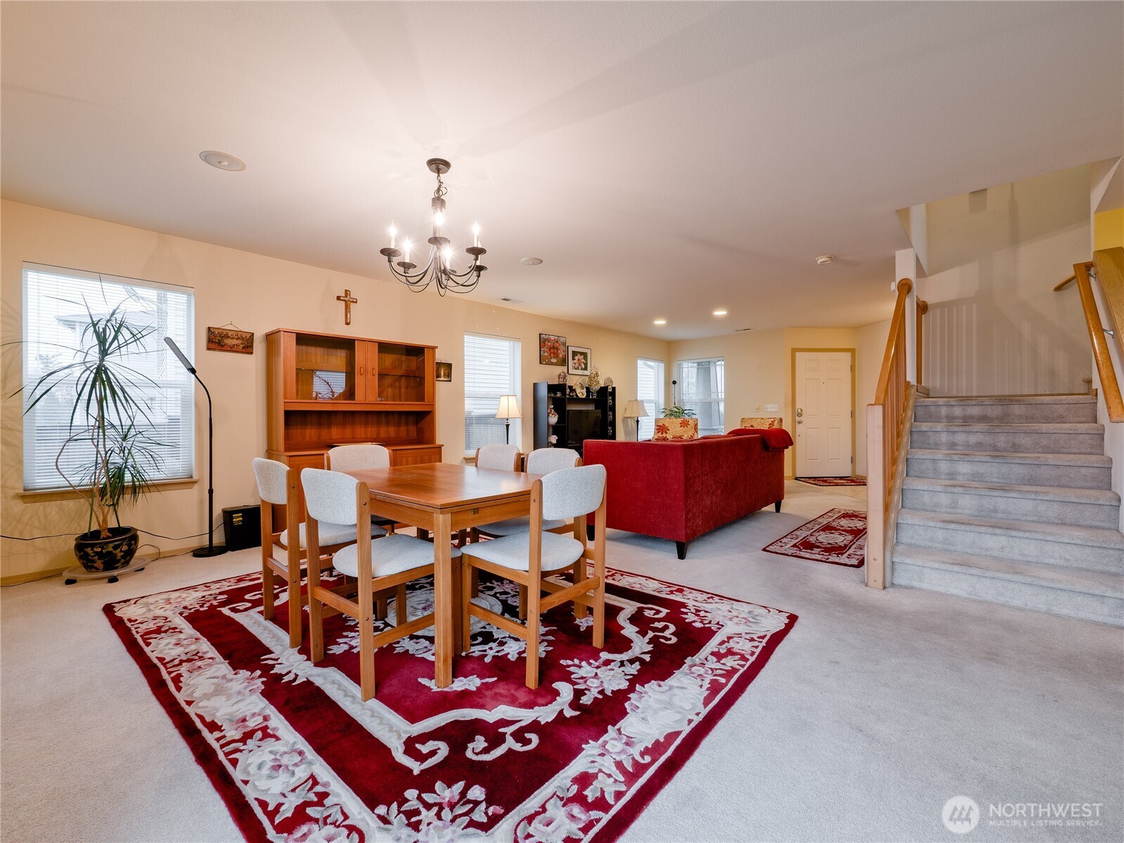 22613 132nd Place Southeast Kent, WA 98042 - Photo 7 of 36 a living room with furniture a rug and a chandelier