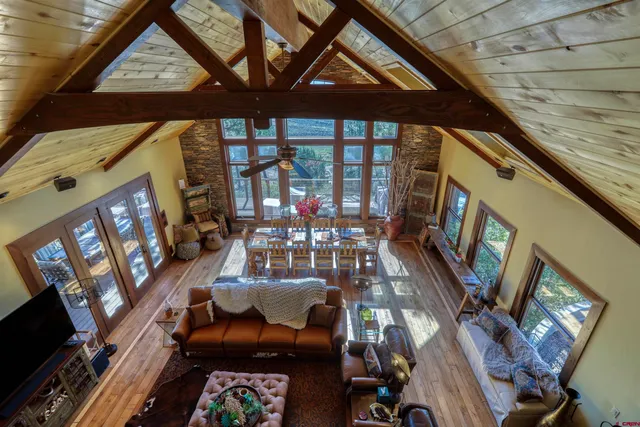 a living room with furniture a fireplace and wooden floor