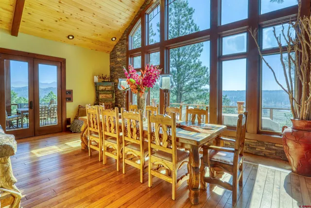 a view of a dining room with furniture wooden floor and windows