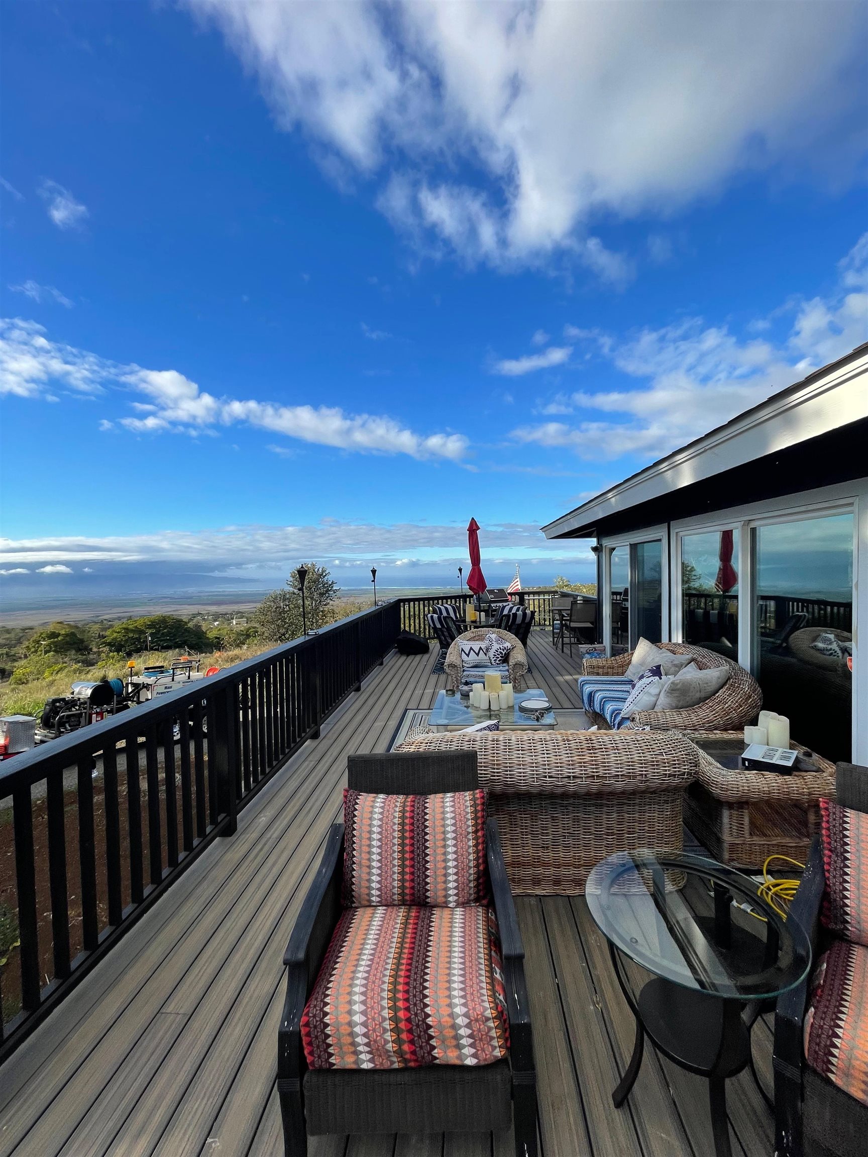 2 Omaopio Road, Unit 2 Kula, HI 96790 - Photo 5 of 8 a view of roof deck with dining table and chairs with wooden floor