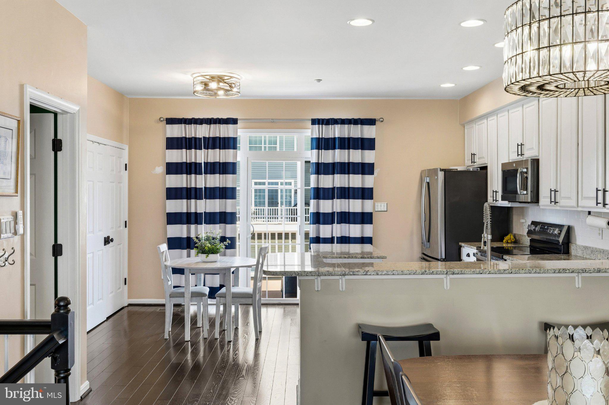 2668 Merlin Court Odenton, MD 21113 - Photo 8 of 42 a dining room with furniture and a floor to ceiling window