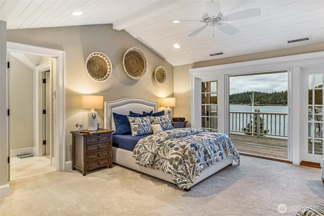 a bedroom with bed and a large window