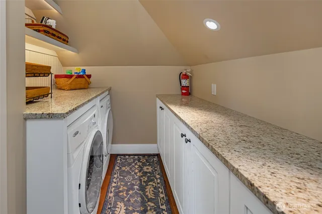 a utility room with sink dryer and washer