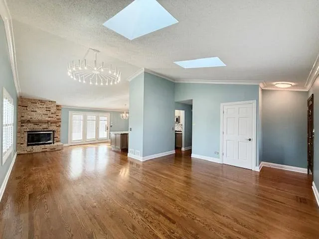 a view of a room with wooden floor and fireplace