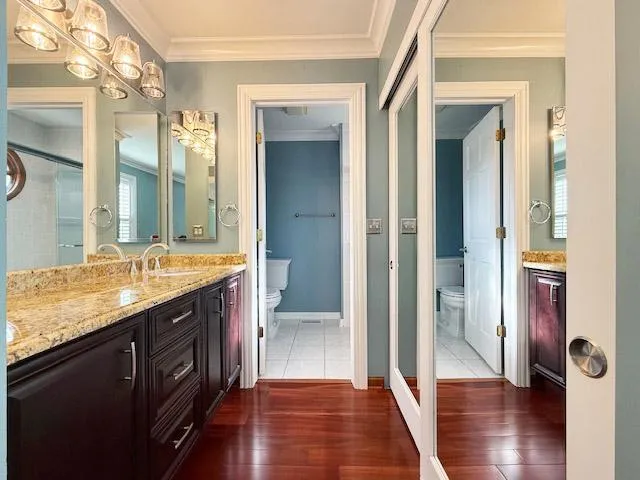 a bathroom with a granite countertop sink a mirror and a shower