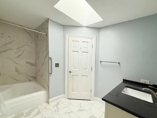 a bathroom with a bathtub and a shower