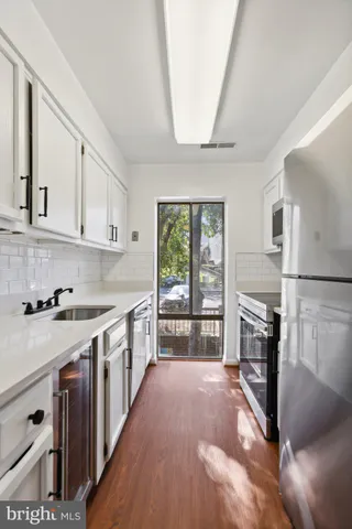 a kitchen with stainless steel appliances granite countertop a stove and a refrigerator
