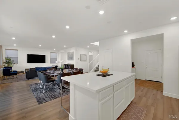a kitchen with white cabinets and appliances