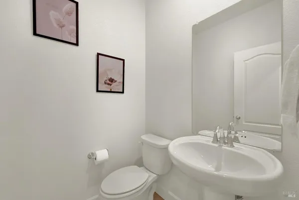 a living room with furniture and painting on the wall