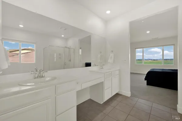 a view of a balcony with chairs and a potted plant