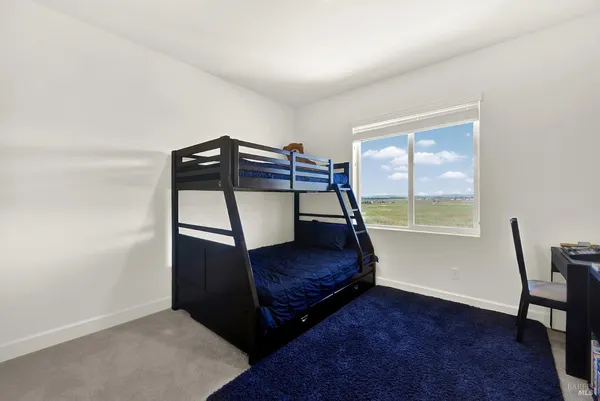 a view of a patio with a table and chairs under an umbrella