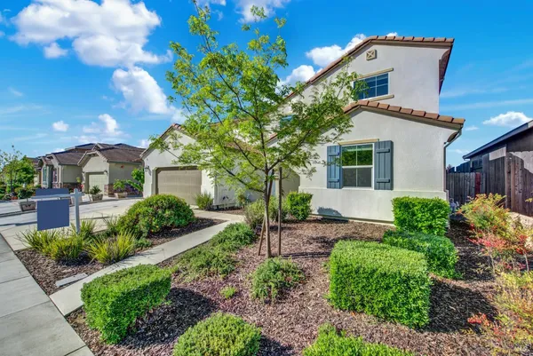 a front view of a house with garden