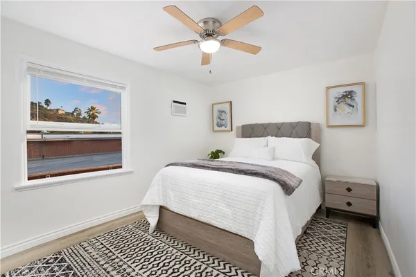 a living room with furniture and a flat screen tv with kitchen view