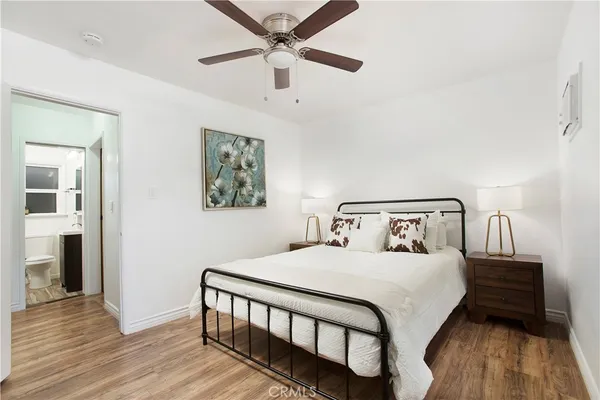 a bedroom with a bed and a flat screen tv