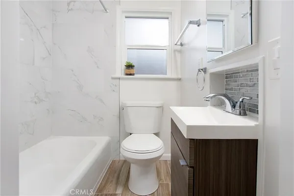 a bathroom with a sink a toilet and bathtub