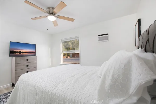 a bedroom with a bed and a flat screen tv