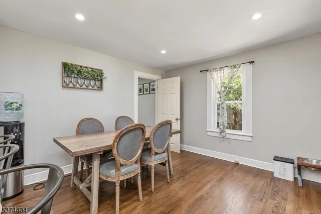 a dining room with furniture and wooden floor