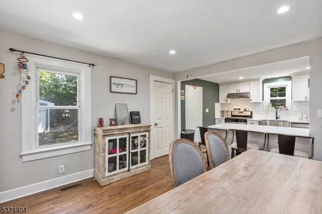 a living room with stainless steel appliances granite countertop a stove and a refrigerator