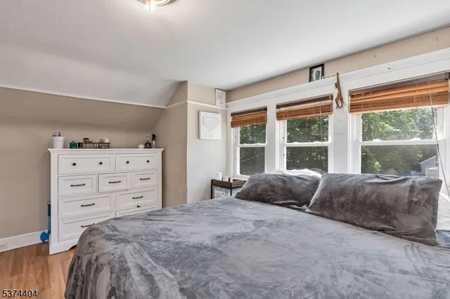 a bedroom with a bed and a large window