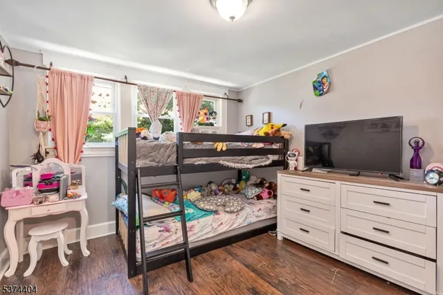a bedroom with furniture and a flat screen tv