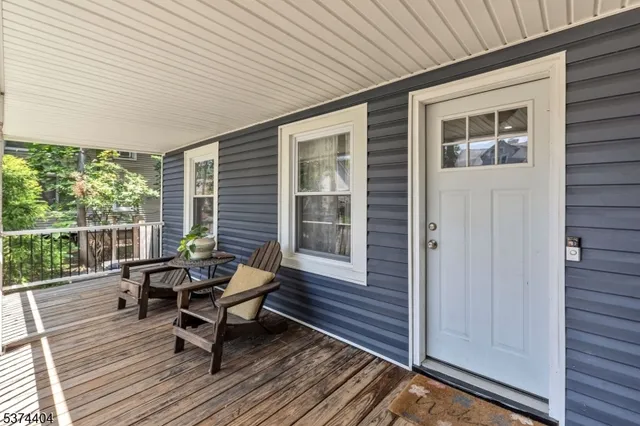 a roof deck with wooden floor and furniture