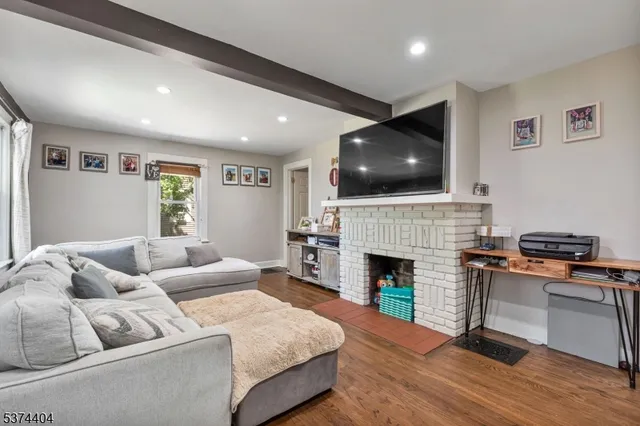a living room with furniture fireplace and flat screen tv