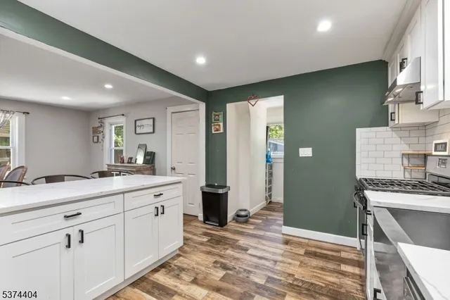 a kitchen with a sink stove and refrigerator