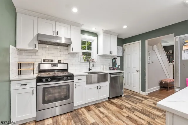 a kitchen with a stove oven and sink