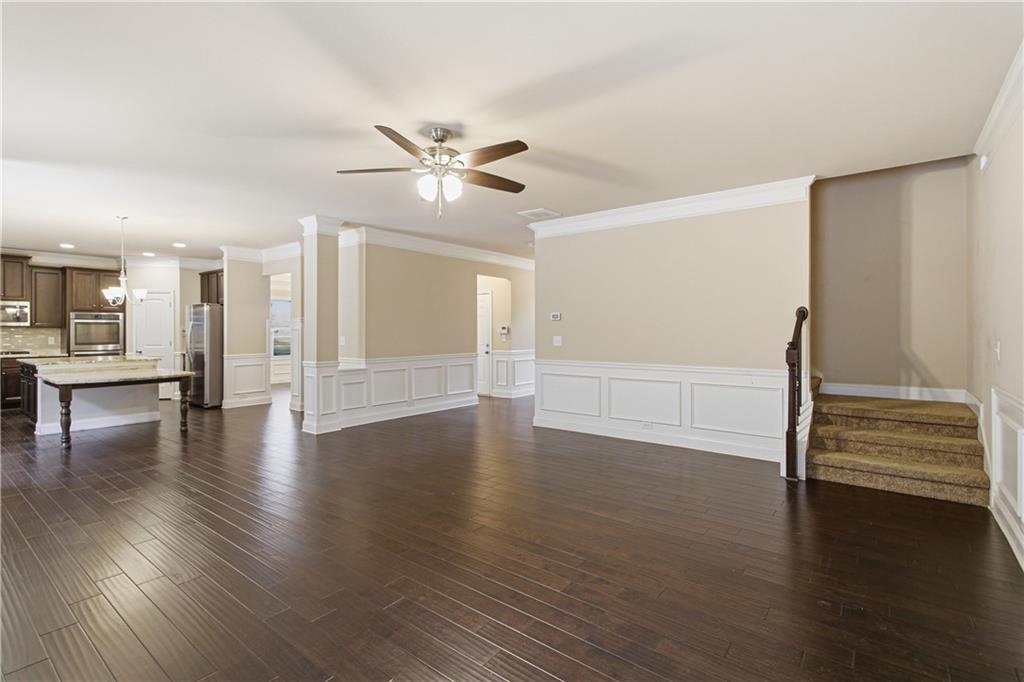 114 Madison Street Canton, GA 30115 - Photo 3 of 39 a view of an empty room with wooden floor and a window
