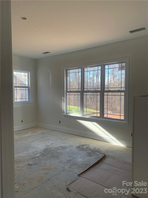 12908 Bailey Road, Unit 193 Cornelius, NC 28031 - Photo 9 of 17 an empty room with a empty space and windows