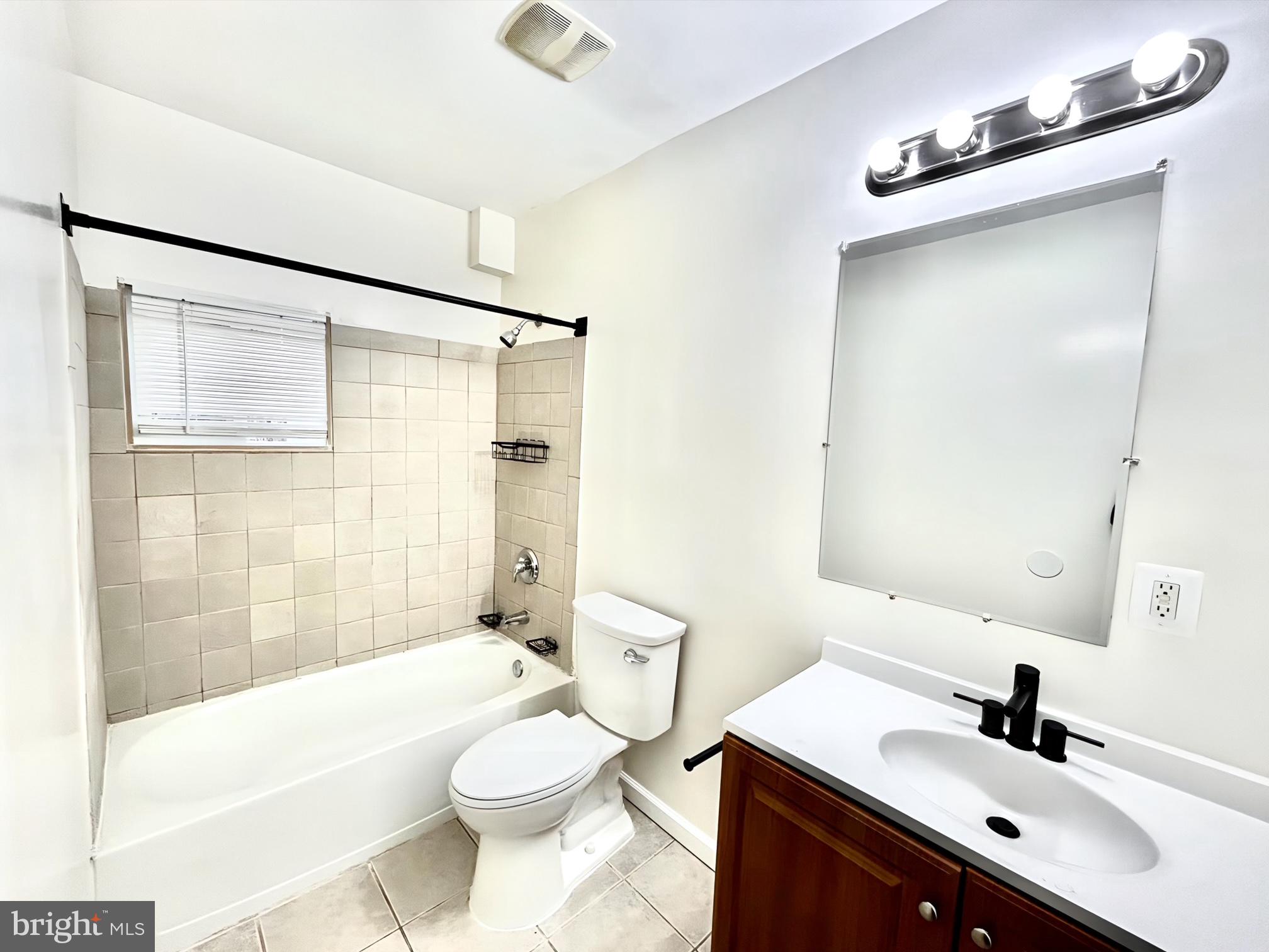 2000 McHenry Street Baltimore, MD 21223 - Photo 14 of 20 a bathroom with a sink a toilet a mirror and shower