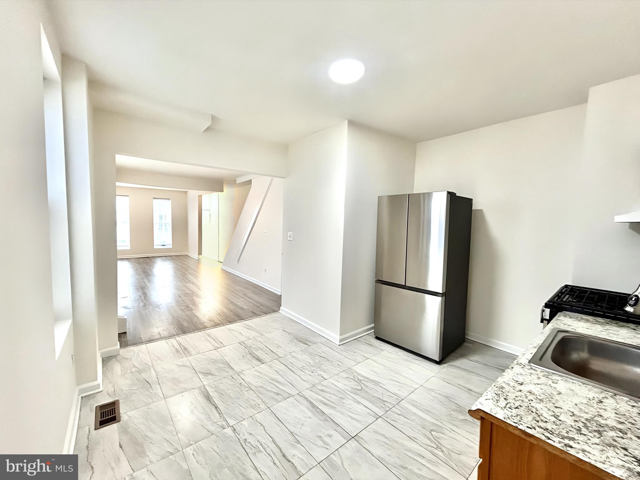 2000 McHenry Street Baltimore, MD 21223 - Photo 8 of 20 a kitchen with a refrigerator and a stove top oven
