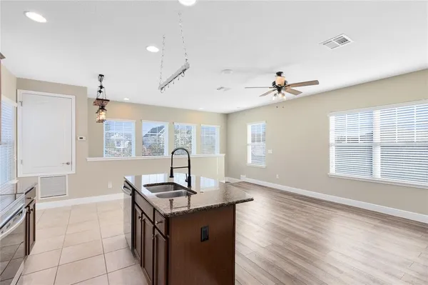 a kitchen with granite countertop a sink and a stove