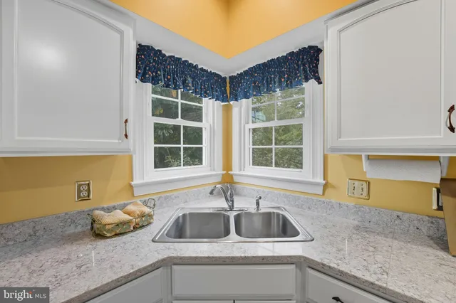 a spacious bedroom with a bed and a large window