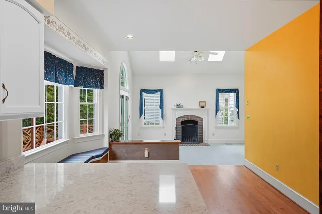 an empty room with windows and ceiling fan