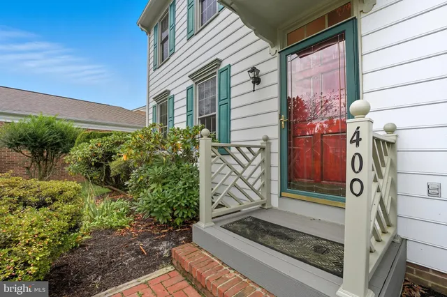 a view of front door with wooden floor and stairs