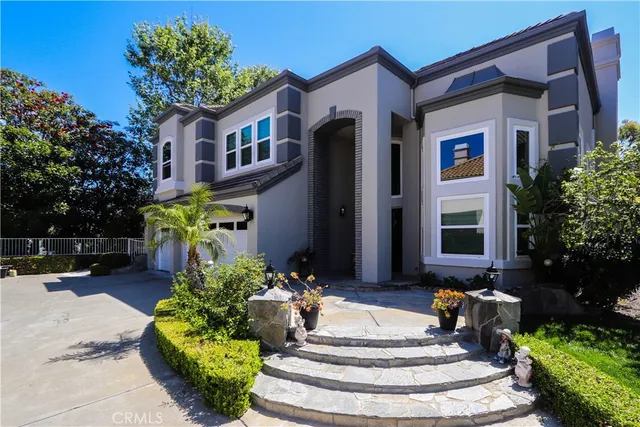 a front view of a house with a garden