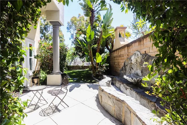 a view of a patio with table and chairs and potted plants