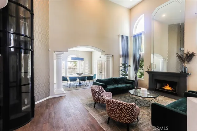 a living room with furniture fireplace and large window