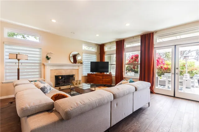 a living room with fireplace furniture and a flat screen tv
