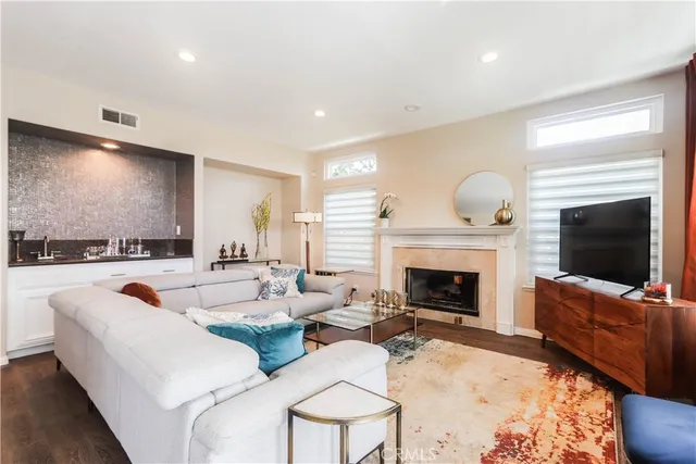 a living room with furniture and a view of kitchen