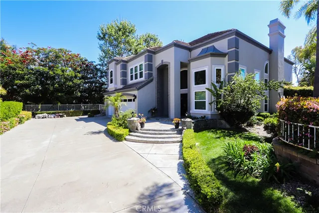 a view of a building with potted plants and a bench