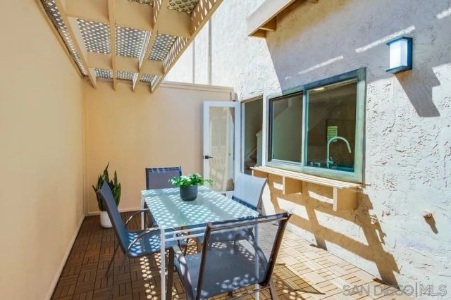 a view of a balcony with table and chairs
