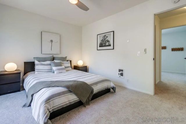 a bedroom with a bed and painting on the wall